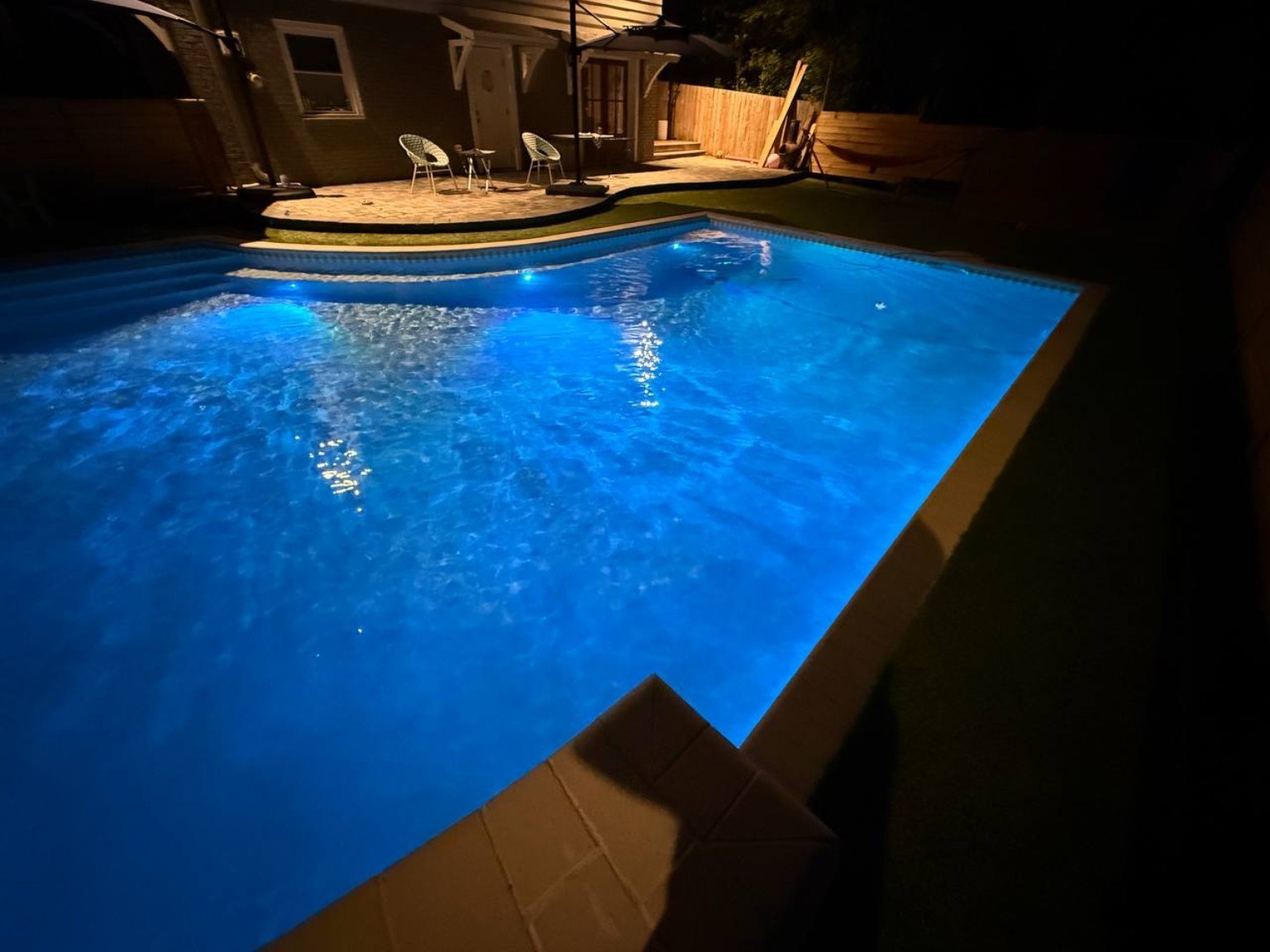 Freeform custom pool illuminated at night