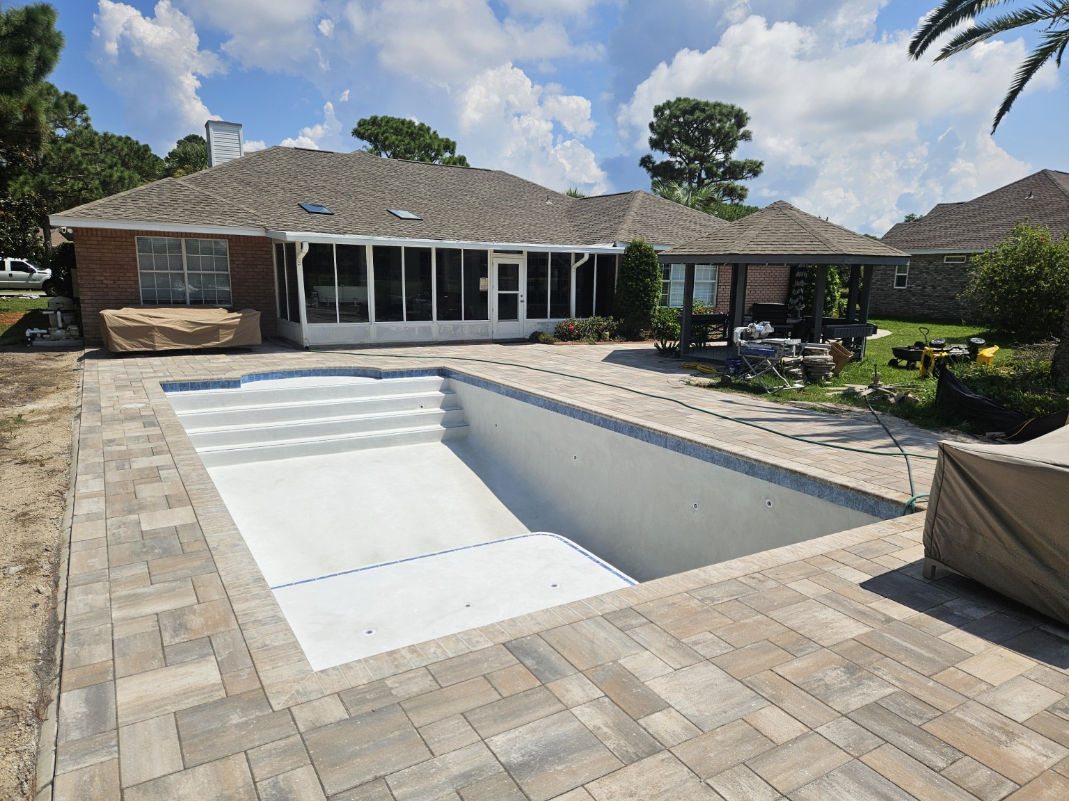 Custom gunite pool with Baja shelf and paver deck
